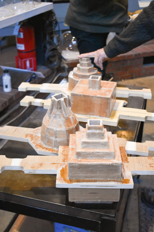 Closeup of various molds of multi-level geometrical towers, used by"Emanation 2019" Artist Allan Wexler.