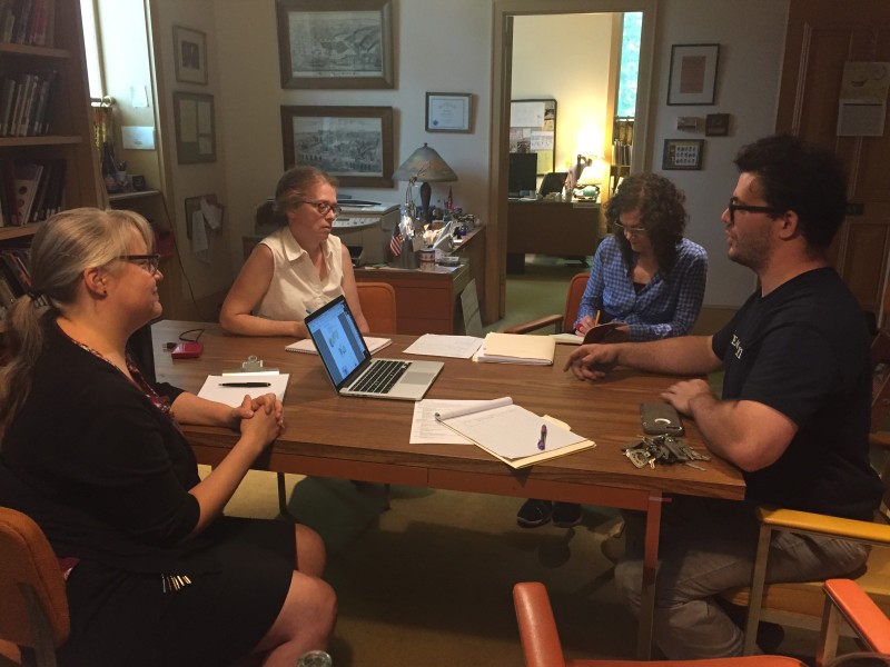 "Emanation 2019" Artists Laura Baird and Martha McDonald sit at a table with WheatonArts Glass Artist, Skitch Manion and Director of Exhibitions and Collections, Kristin Qualls.