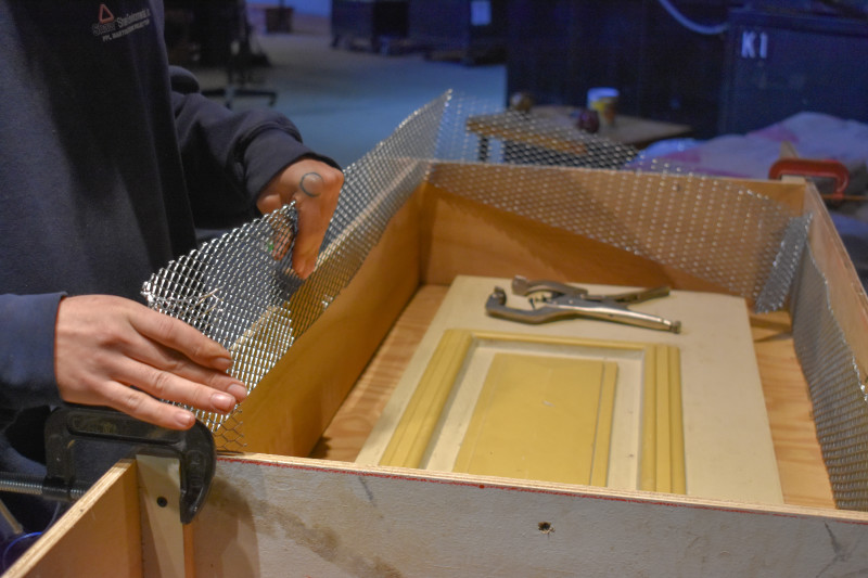 Glass Studio Artist, Jarryd creates a wire infrastructure, prepping for a mold of one of four door panels from the Museum