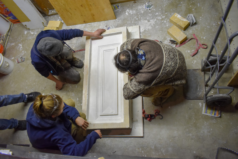 Glass Studio Artists inspect the completed plaster mold