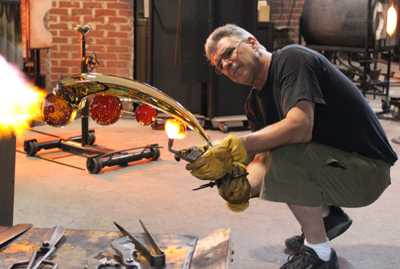 Richard Royal creating a glass sculpture in the WheatonArts Glass Studio
