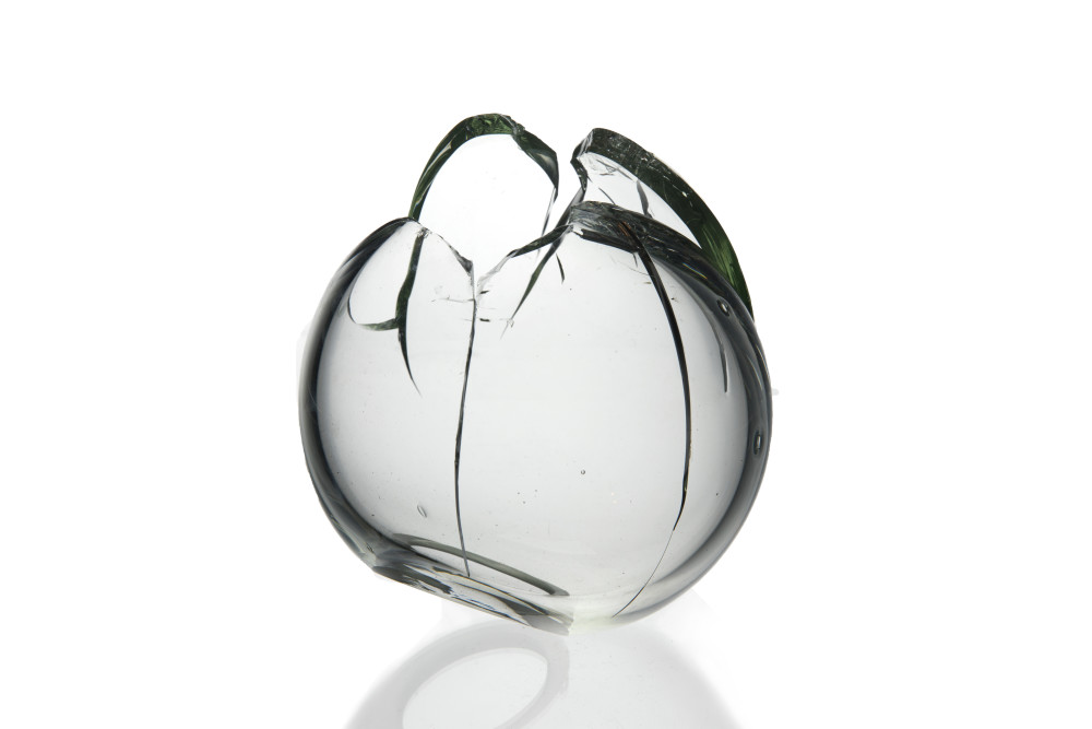 Broken clear glass sphere. Artwork: Romina Gonzales, Stable Form (from the Molecular Tension series), 2018, Glass, 5” x 5” x 6”