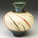 A wide yellow vase that is smaller at the foot. Stripes of green and red resembling blades of grass go around the body from bottom to just before the neck. The green neck is thin and widens as it reaches the lip. Created by Michael Cho