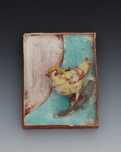 A clay sculpted yellow bird on a brown and blue clay backdrop. Created by Priscilla Dahl.