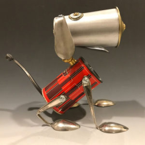 A dog fashioned out of several metal objects such as spoons and cans. Created by Brian Marshall