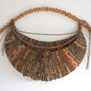 A wide crescent shaped basket with a long textured yellow handle and several red accents throughout. Created by Samuel Yao.