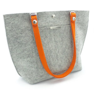 Grey felt bag with a bright orange handle by Maureen Buzzeo