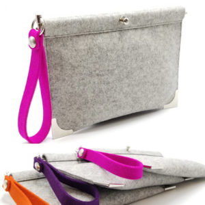 Small grey felt clutch with a strap coming in different colors. Created by Maureen Buzzeo
