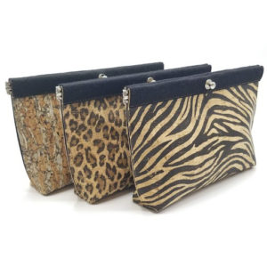 Three animal print clutches with a black bar at the top and a silver clasp. Created by Maureen Buzzeo
