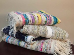 Blankets stacked on top of one another by Belinda DeCicco