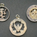 Three metal coin pendants carved by Allan Feinberg