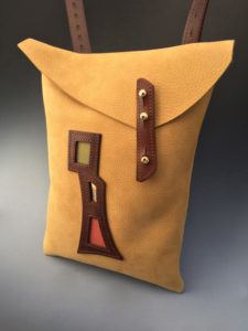 Rectangular yellow leather bag by Jorge Gil with brown leather straps and embellishments.