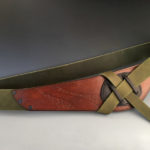 Green leather belt with an orange brown front. Created by Jorge Gil