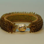 Amber color bracelet by Naomi Johnson with a small amber charm in the center