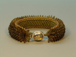 Amber color bracelet by Naomi Johnson with a small amber charm in the center