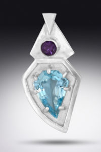 A silver pendant by Paul Lorber decorated with blue and purple faceted gemstones
