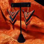 A matching pair of tiered red and black striped triangle beaded earrings by Sharon Manewitz