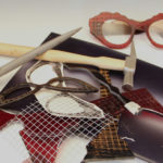 a collection of tools, glass, and other pieces used to make eyeglasses by Laurie Olefson