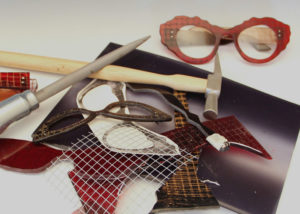 a collection of tools, glass, and other pieces used to make eyeglasses by Laurie Olefson