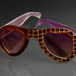 Heart shaped red sunglasses with a yellow cross hatch pattern. Created by Laurie Olefson