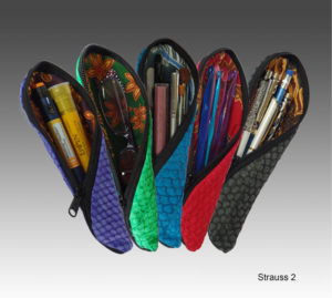 Five fish leather pouches by Lisa Strauss in available colors showcasing the versatility of use, from holding an epipen, eyeglasses, makeup supplies, crochet needles, or stationery.