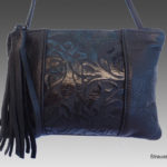 Deep prussian blue purse by Lisa Strauss with a fringe decoration and botanical patterns