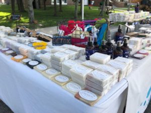 A booth showcasing the soaps, loofahs, and bathroom accessories from LEH Soap Company.