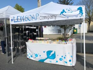 A booth showcasing the products of LEH Soap Company.