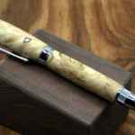 A closeup of a smooth tan wooden pen. Created by Thomas Ferrie.