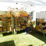 A booth showcasing the woven baskets of Mary May.