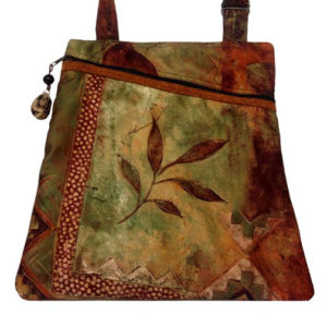 A deep red and green bag with a matching strap and a leaf motif. Created by Agustin Ruiz.