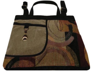A black and brown patterned purse with a black trim, handle, and strap, created by Agustin Ruiz.