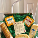 A gift box of cheeses and a row of crackers by Keystone Farms Cheese.