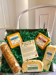A gift box of cheeses and a row of crackers by Keystone Farms Cheese.