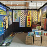 A booth showcasing the floor cloths of Ellie Wyeth.