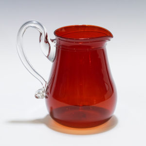 Red reproduction of a glass "Jame Lee Pitcher" with a clear handle.