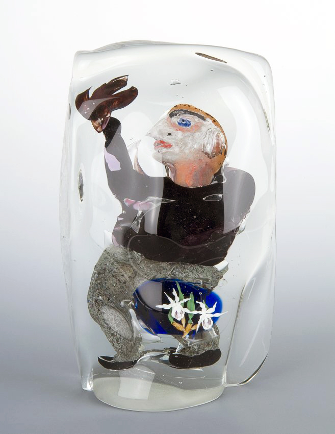 A paperweight by Dan Dailey and Lino Tagliapietra. A man in profile behind small, white flowers, all encased in clear glass. Dan Dailey and Lino Tagliapietra, Collona, 1989, Photograph by Al Weinerman with The Lens Group