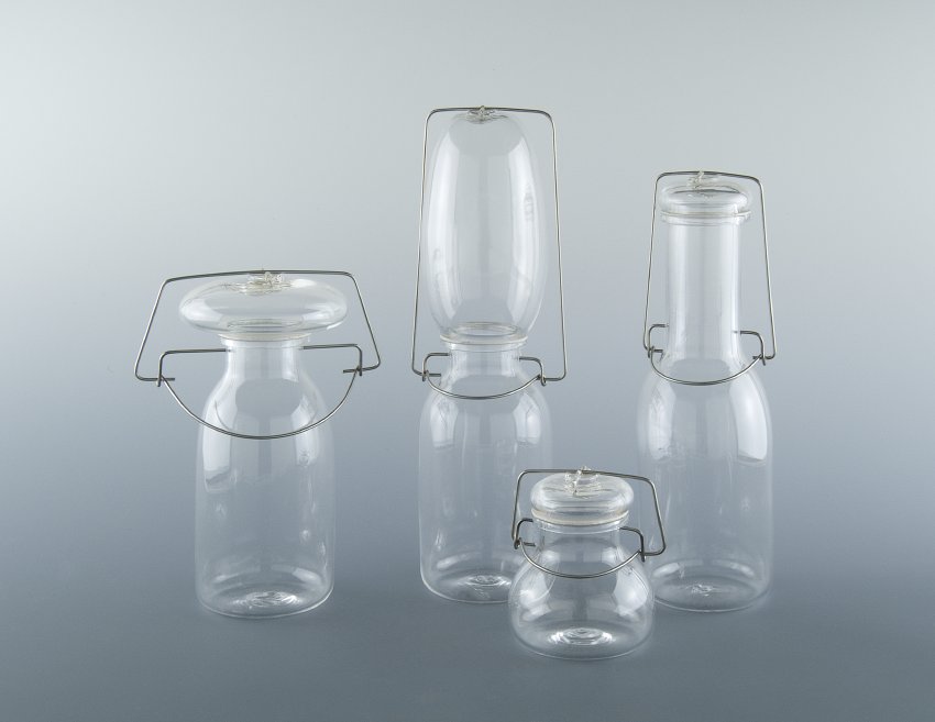 Four clear glass jars in unconventional shapes. Some have long necks, some have wide lids. Miyuki Nishiuchi, There is a Reason Why Things are the Way They Are, 2002.
