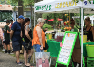 Woman ordering a Twisted Lemonade from a food vendor at WheatonArts.