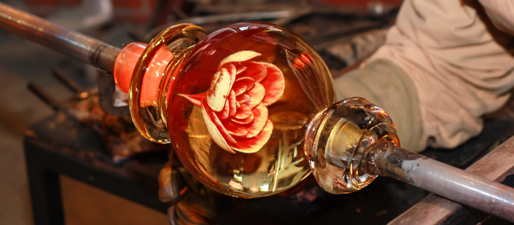 Closeup of a Glass Artist working on a Millville Rose.