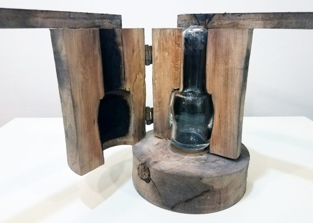 Glassblowing Mold, Robert Broschart, 2020. Turned cherry wood. Donated by the Artist. The wooden mold is opened to reveal a glass vessel within.