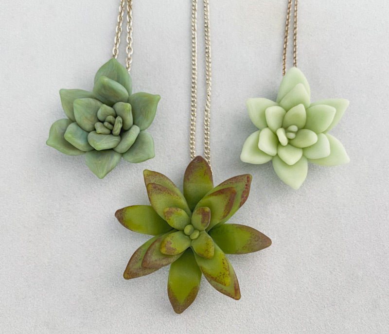 Three succulent pendants in shades of green, by Dominique Jean Bebak.