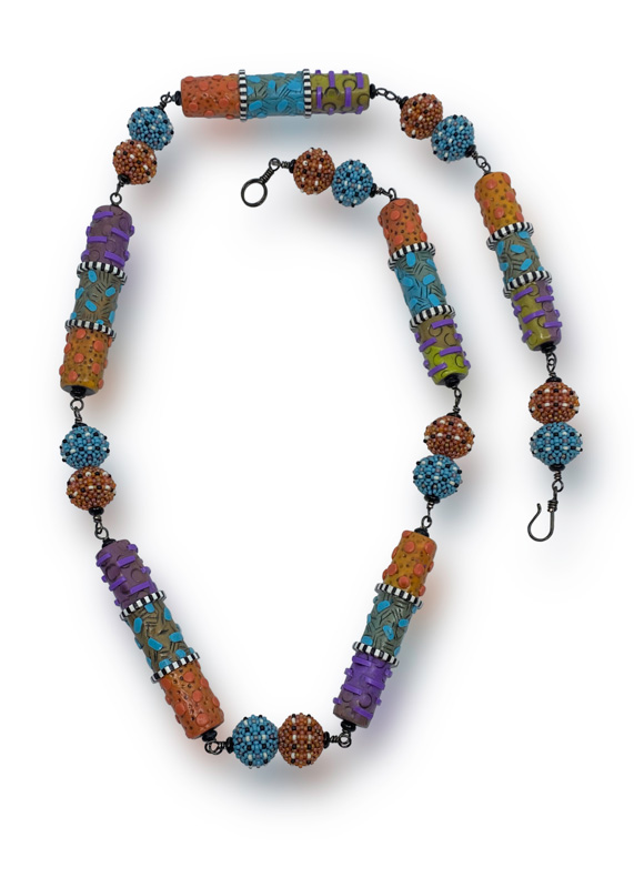 A necklace by artist Sheila Fernekes with circle and oblong textured beads in orange, blue, green, and purple.