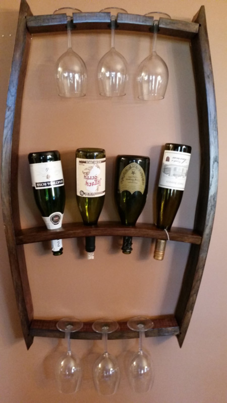 A wine rack by Sharon Knapp holds several wine glasses and bottles.