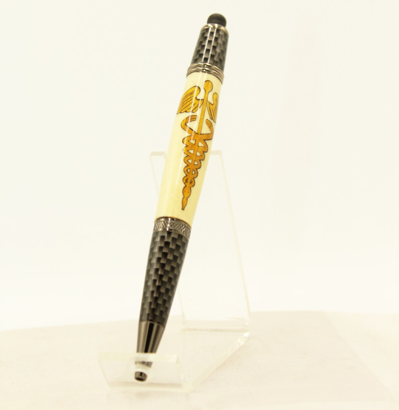 A pen by artist Larry Morgan. The wooden design has a yellow, lined image of Caduceus, a winged staff with two snakes.