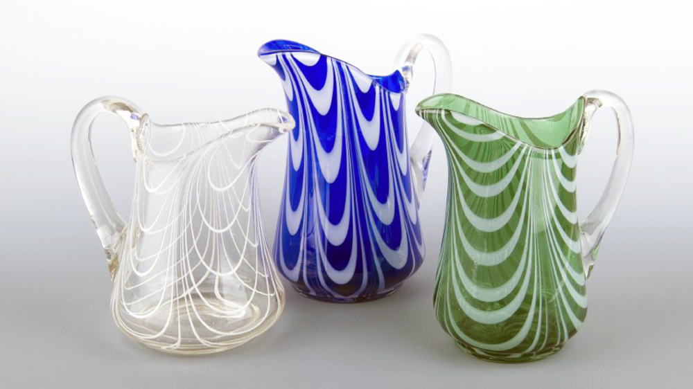 Left to right: 1 (white & clear). Pitcher made by John Ruhlander at Whitall Tatum Co. c. 1900. Gift of Frank H. Wheaton, Jr.; 2 (blue & white). Pitcher made by John Ruhlander at Whitall Tatum Co. 1901-1905. Gift of the Glass Research Society of New Jersey in memory of John Braniff; 3 (green & white). Pitcher made by John Ruhlander at Whitall Tatum Co. 1901-1905. Gift of the Glass Research Society of New Jersey in memory of Blanche Jost. Photo by Al Weinerman.