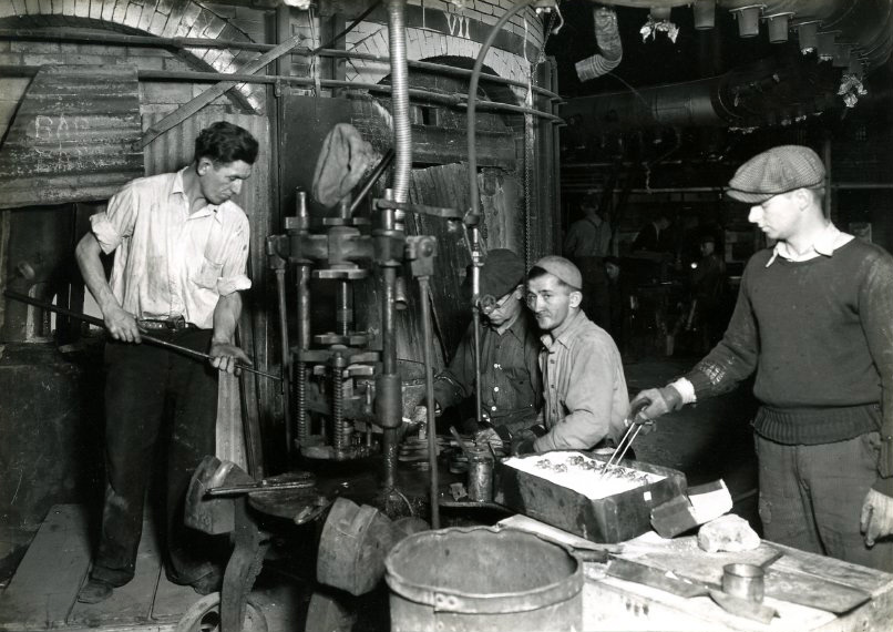 WPA at Wheaton Glass Co hand pressing, c1936. Black and white photo of four men working.