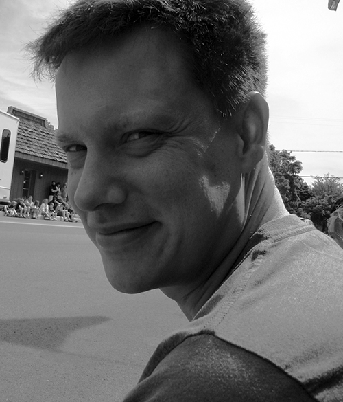 A black and white headshot of Artist Norwood Viviano.