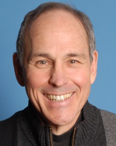 Headshot of storyteller Gerald Fierst with a toothy smile.