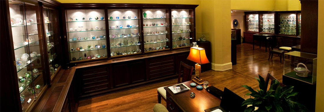 A wideshot of a bountiful collection of Glass Paperweights.